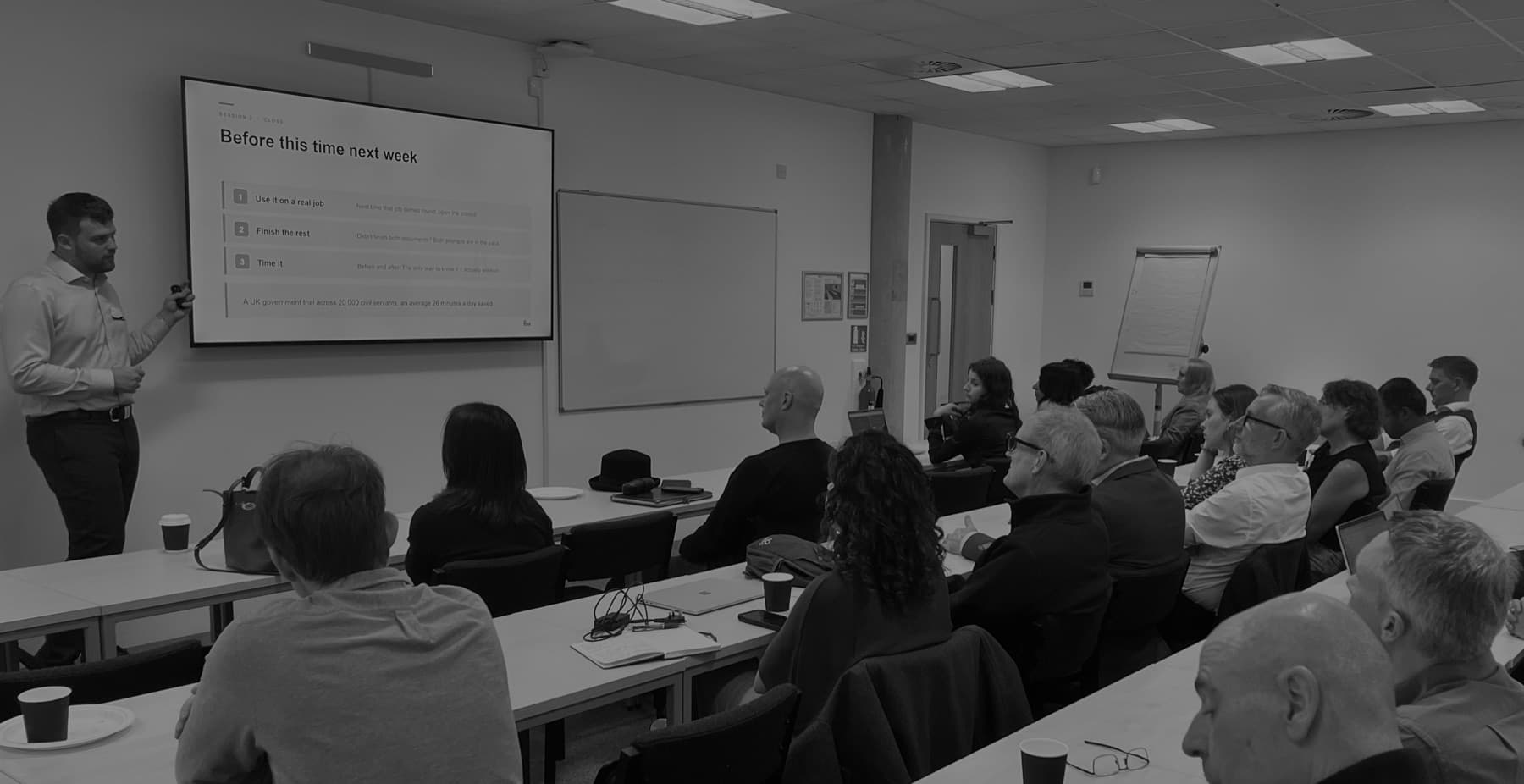 Will May teaching a full room at the Thames Valley AI Hub in Reading, with a slide on screen reading Before this time next week